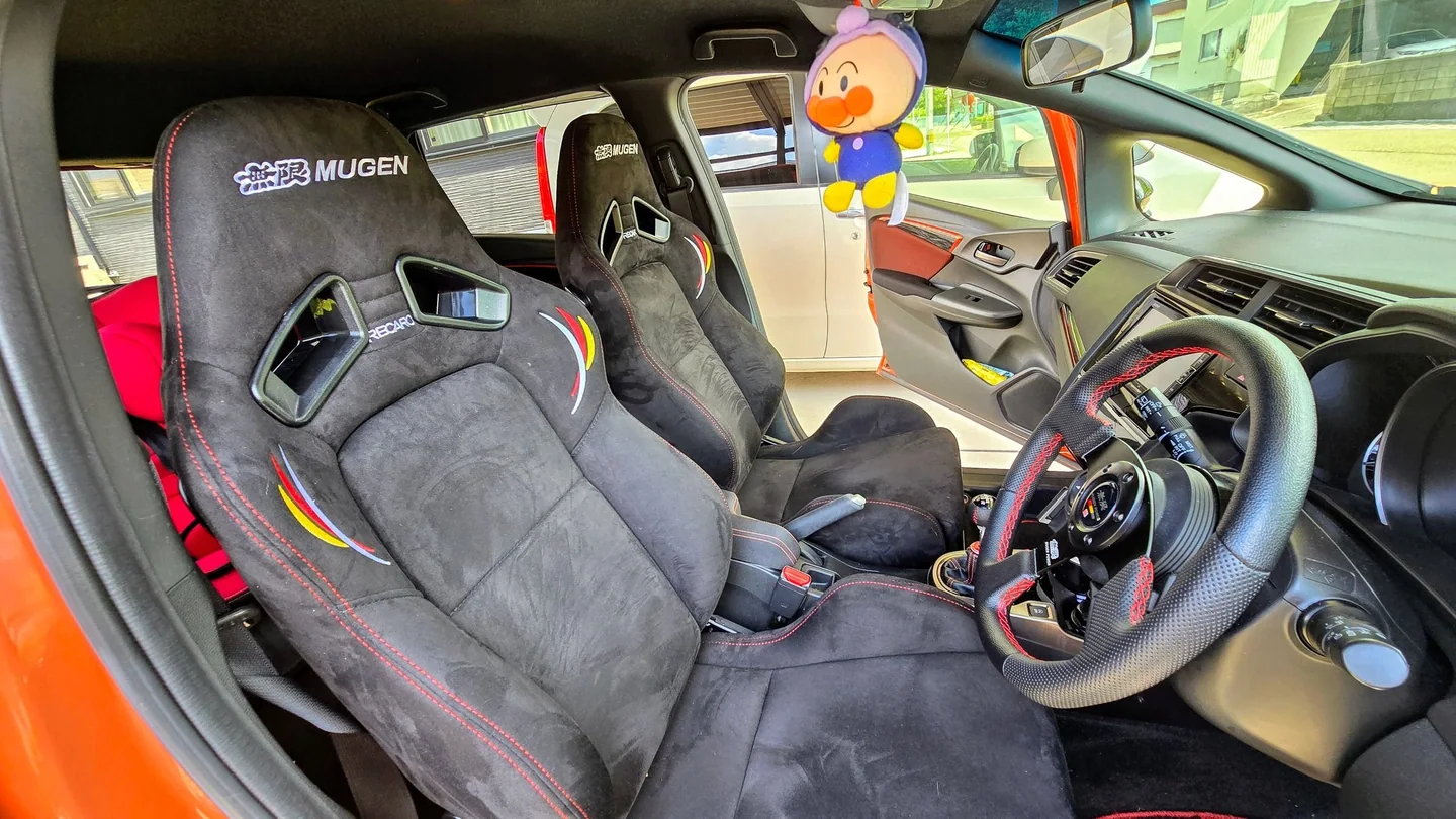 無限RECAROシート、無限ステアリング、純正スイッチ、6速シフトを備えたHonda Fitの室内。